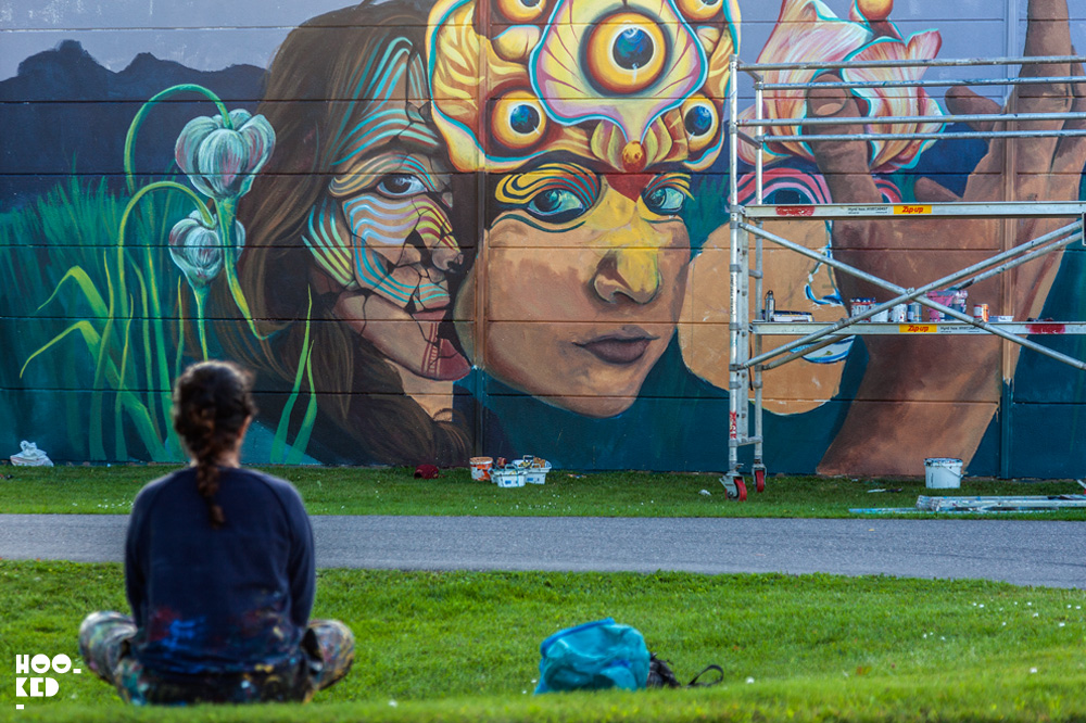 Colombian street artist Gleo looks over her mural at work painting a mural in Falköping, Sweden
