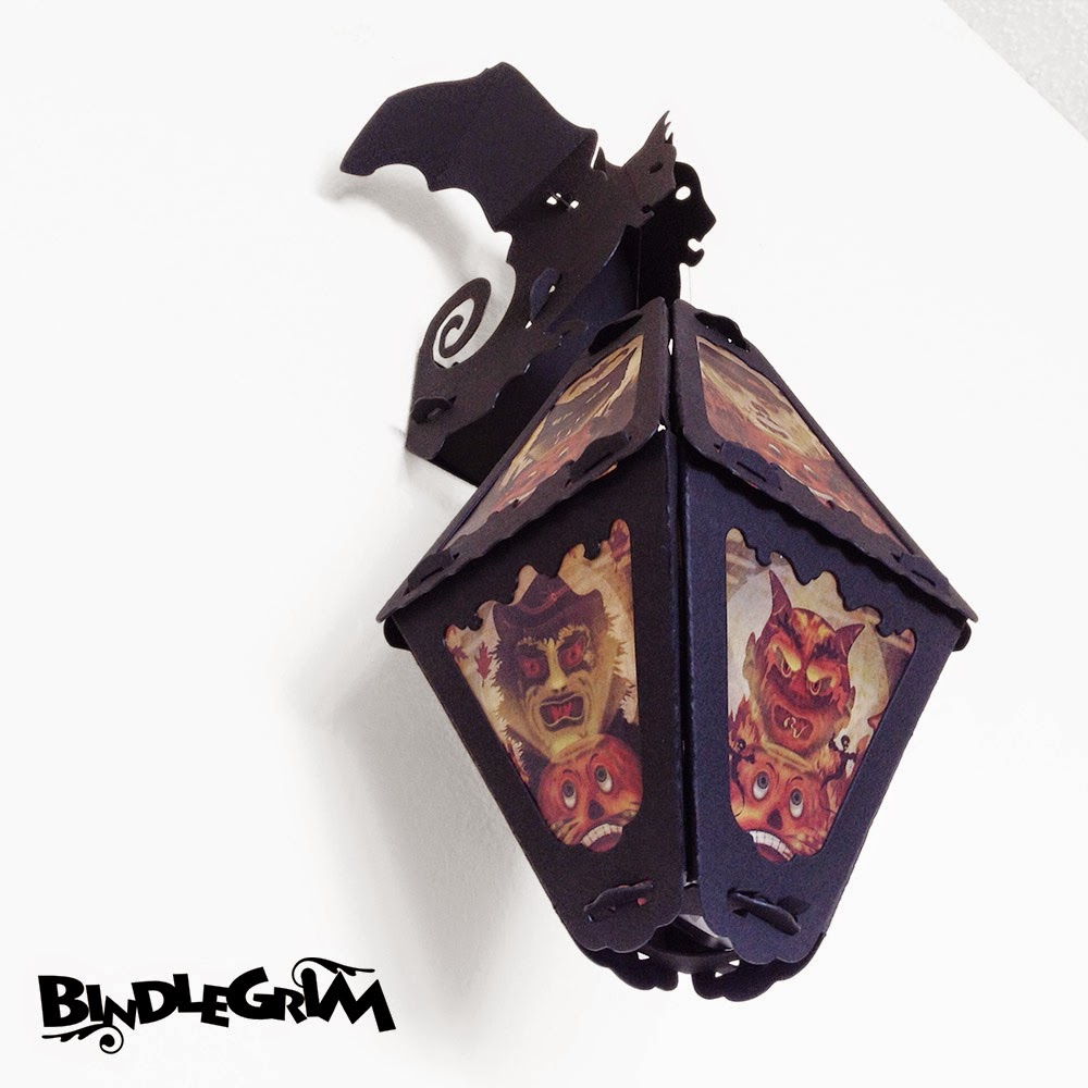Vintage or vintage-style lanterns hang from the wall with this bat wall-hook decoration by Bindlegrim