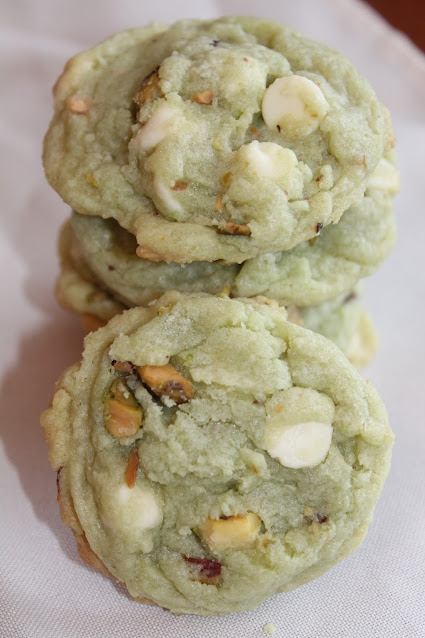 Close up of a baked white chocolate pistachio pudding cookie.