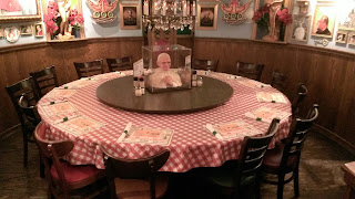 circular table at italian restaurant with pope head in middle