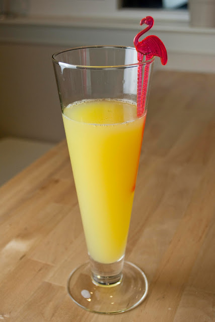 a tropical dream cocktail, vanilla vodka, malibu rum with mango, coconut rum, banana schnapps, orange juice, pineapple juice