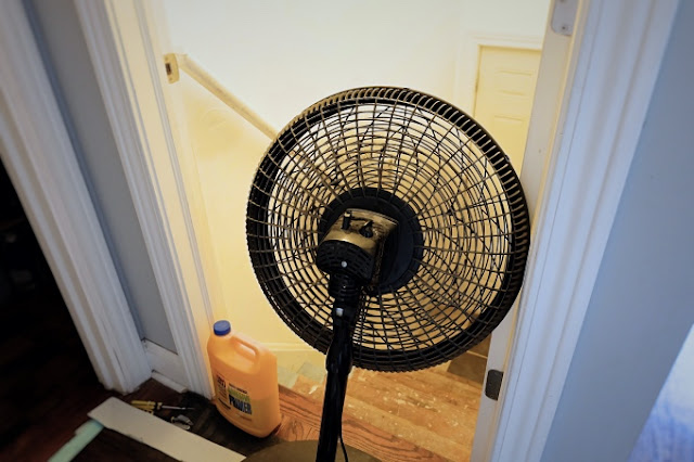 fan propped at the top of the stairs to encourage drying