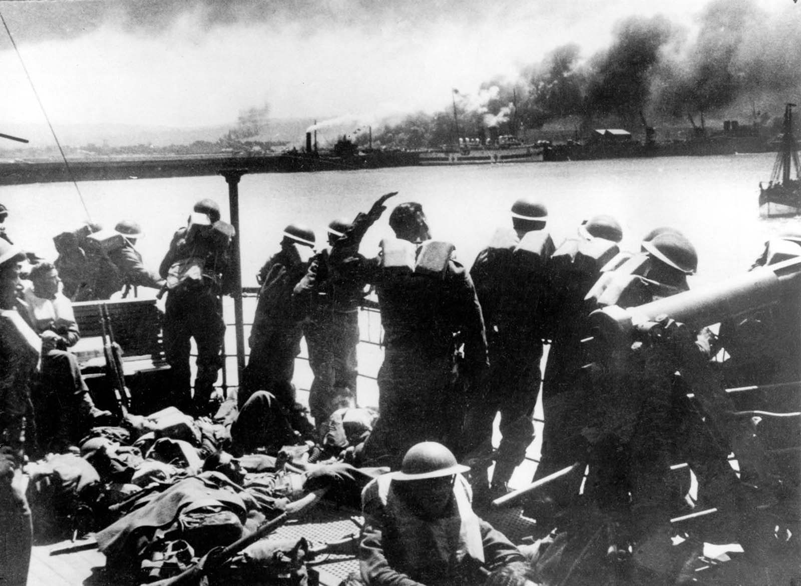 British Expeditionary Forces view the German bombardment of Dunkirk from an evacuation transport.