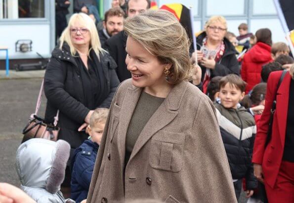 Queen Mathilde visited the 'Fly to the Moon' project of Maison des Ateliers Mons. Natan dress and Armani wool coat