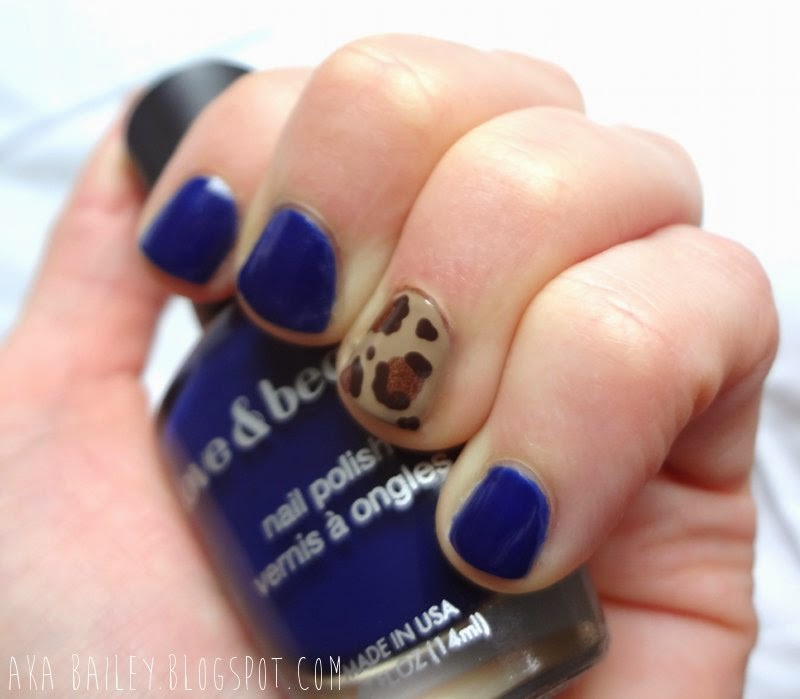 Navy nails with leopard print accent