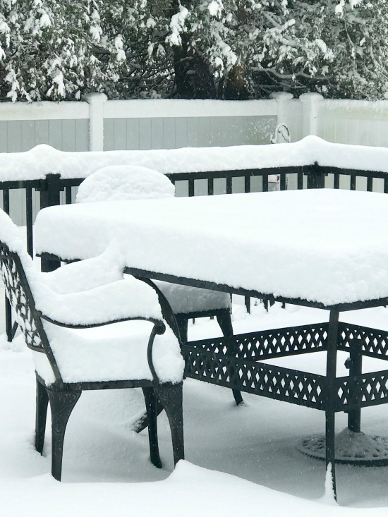 Patio furniture covered with snow
