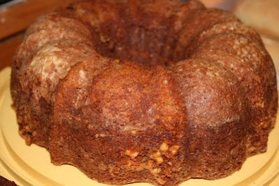 A homemade bundt cake made with bananas and maple with a swirl of nut praline in the center.