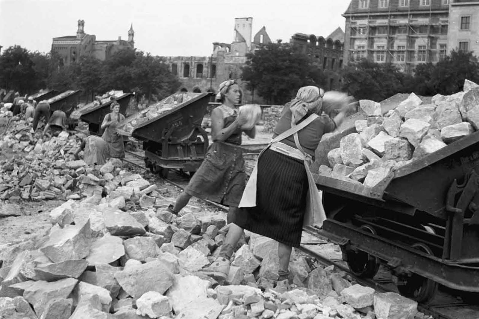 Women cleaning up the destroyed city. 