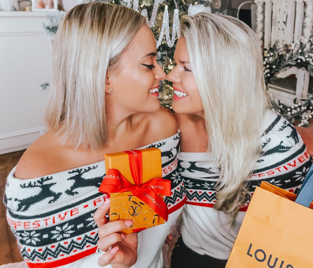 whitney and megan looking at each other in christmas jumpers with louis vuitton giveaway