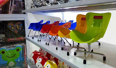 1/6 scale Daiso plastic chairs on display.