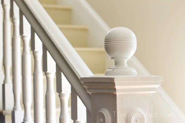 100 year old newel post with glossy white paint