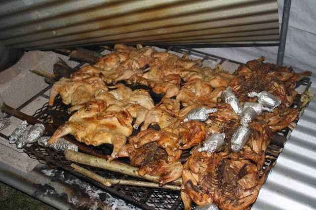 Chicken cooking on an outdoor grill.