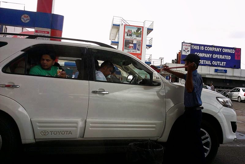 Man washing windshield at gas station