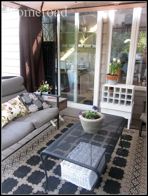 Outdoor furniture, rug and coffee table.