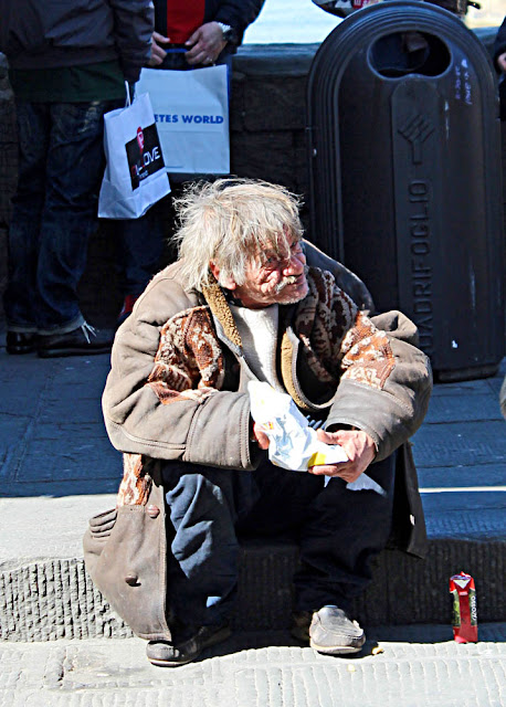 close up of tramp eating on pavement