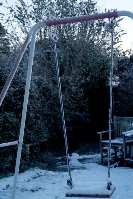 snow covered swing