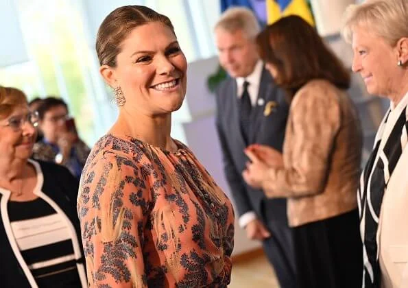 Crown Princess Victoria wore H&M print silk dress and Gianvito Rossi pumps, and Kreuger Jewellery rose gold poppy earrings