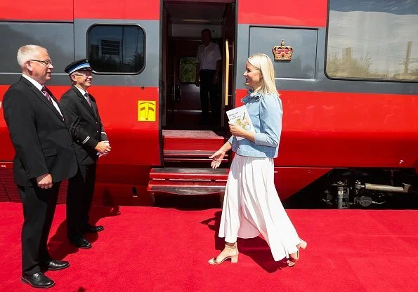 Princess Mette-Marit wore Ulla Johnson Wes bow embellished denim blouse. Crown Princess talked with Author Monica Isakstuen at Egersund library