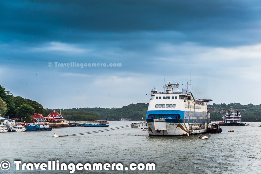 Taking a cruise on Mandovi river and experiencing the dynamic city Panajim by water is considered as one of the must do thing in Goa. Although options available during Monsoons are comparatively lesser. But still we thought of taking a cruise on Santa Monica, which is managed by Goa Tourism Department. This Photo Journey shares some moments from this cruise experience and more details on various options available in and around Goa.The Goa Tourism Development Corporation (GTDC) runs a variety of river cruises on the Mandovi river during daytime, sunset and moonlight. There are two types of day cruises which start from the Panaji jetty, down the Mandovi into the Zuari bay and up the Mandovi to Aldona and a mineral water spring. There are few private firms who also offer a variety of imaginative cruises or boat tours for sunset views as well as for crocodile or dolphin spotting. but we found is hard to identify these options during monsoons. Many of the folks gave us the reason that it's risky during monsoons to go deep into the sea, while we noticed many of the fishermen boats at a distance. Most probably, it's related to business reasons & low tourist inflow during monsoons.We opted for evening cruise from Goa Tourism office which is near to Mandovi river bridge which connects North Goa to it's southern part & Panjim. Santa Monica is considered as a pride of Goa Tourism Development. This is used for daily evening cruises on river Mandovi with 'live' cultural programs performed by the best cultural troupes of Goa. Usually one cruise duration is 1 to 1.5 hrs and it takes multiple rounds in evening. Ticket was 200 Rs per person which quite cheap. Santa Monica has huge capacity so Goa Tourist makes enough money. And don't miss the video of a gentleman dancing at the cruise :) . It's placed in the bottom of this postAt any point of time Santa Monica can accommodate approximately 200 guests. Inside the cruise, there is usually a bar counter which also serves very basic snacks, but not very exciting affair. very badly managed and crowd makes it worse. So we didn't even try to go near it. And fortunately it was just one hour. Santa Monica is also available for special parties on hourly basis and it seems, many folks book it for weddings as well. The Santa Monica cruise is the most attractive entertainment with live Goan Cultural Show and music on board. We loved this the most. There were some Goan performances by very sweet performers on the cruise. These performances keep you busy most of the time and you need to put efforts in taking out your attention & view other things around the river.As ride starts, it moves across the riverside with beautiful views of Panjim town. Then it moves towards the other and goes deep into the river. Various ships and steamers come on the way and many of the ships are used for local transportation. Many folks use these ships to cross river with their vehicles.There are different types of cruises available in Goa. Sunset Cruise one of the famous one which departs at 6.00 pm for one hour. The other one which starts at 7:15pm is known as Sundown Cruise. There is a special cruise called as Full Moon Cruise, which starts at 8:30pm & it's for 2 hours.  'Dolphin Fantasy Cruise' sounds very interesting :) . This cruise is only available on Mondays, during mornings. I guess, for 2 hours. Idea is to watch the dark graceful water beauties in a playful mood and the rhythmic dance of love - yes we are talking about Dolphins in Goa. This cruise helps in sighting closely the head lands jutting out into the sea, the Raj Bhavan, Aguada Fort & Reis Magos. There is another cruise offered by Goa Tourism - 'Pearl of the Orient'. I loved these names :) ... This is an interesting cruise with walking experience which helps in exploring natural & cultural heritage by visiting World Heritage Monuments at old Goa. We were not aware of this option when we visited Goa, otherwise this would have been our first option. This happens only during Saturdays and timings are from 9:30am to 1pm.If you want to experience Backwater Thrills cruise, plan your visit between Tuesday & Friday. Weekenders would miss this. This starts at 9:30am and ends at 4pm. It's about cruising along the riverine tip of Islands of Chorao, Divar, Old Goa. This cruise is very interesting for endless sights and sounds of Mandovi’s thick mangroves. Cruise offers the experience of typical Goan cuisine served in earthen pots and banana leaf. It seems that Goa tourism also arranges special cruises for longer periods of time. Panaji jetty ticket counter is best place to find out more details about cruise options in Goa.Cruising around Goa is a fun activity and Goa Tourism department really does a very good job in managing these cruises very well with great flavor of goan culture and music. It's real fun to enjoy goan music on cruise with awesome performers. Most of the times, they also play music for guests, if they want to dance in the middle of the river :). If you plan for the cruise in Goa, be prepared for the long waiting queues and I am sure that wait would be more during the season. But it's all worthwhile.