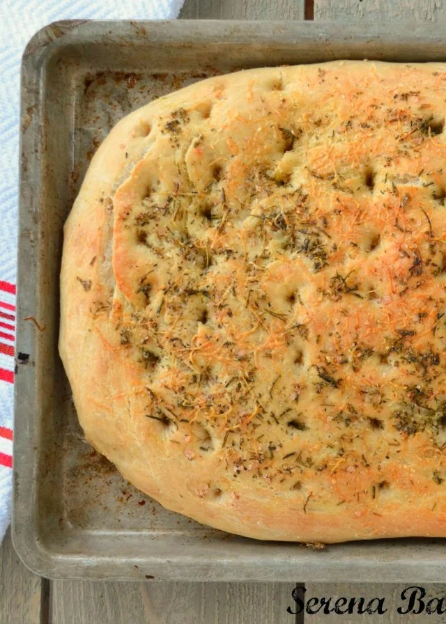Herbed Focaccia Bread recipe is with rosemary, salt, and parmesan cheese is perfect for Italian night or an alternative for rolls at Thanksgiving and Christmas from Serena Bakes Simply From Scratch.