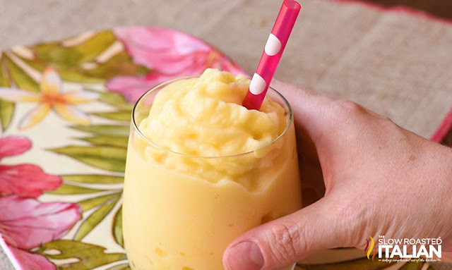 Dole pineapple whip in a glass held by a womans hand