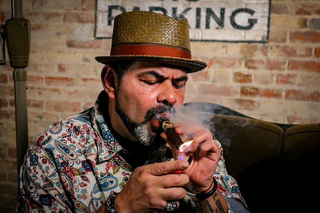 a rich man smoking a Cuban cigar