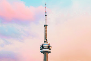 a pink and blue sky with a radio tower
