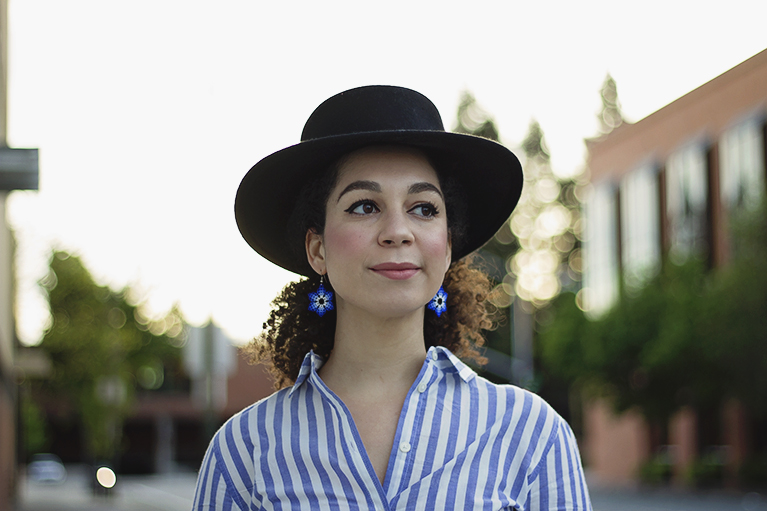 natural hair style worn with a hat