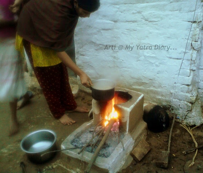 A local village girl makes chai in India