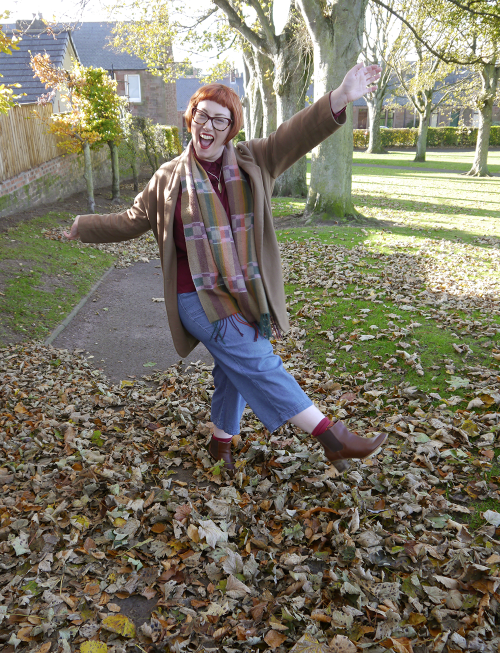Having fun with seasonal dressing Kickin up leaves in the park while wearing an outfit of autumn colours