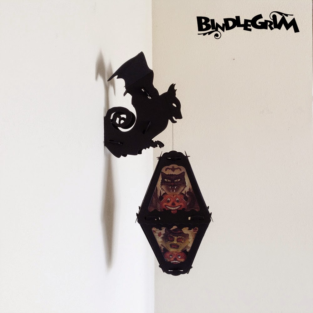 Wall hook decor (in a bat shape) holds a Halloween paper lantern vintage style decor by Bindlegrim