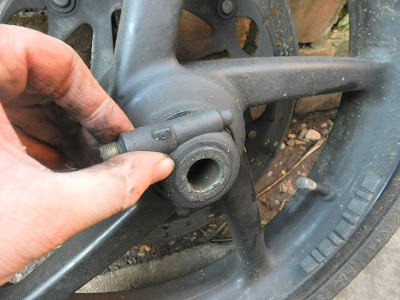 Aprilia RS 125 front wheel removal to access brake disc . remove speedo drive unit .