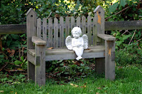 angelito en un banco de jardin