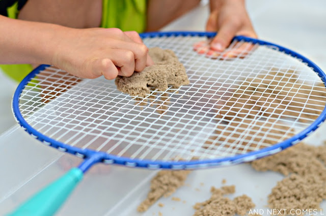 Poking kinetic sand in a fine motor sensory activity