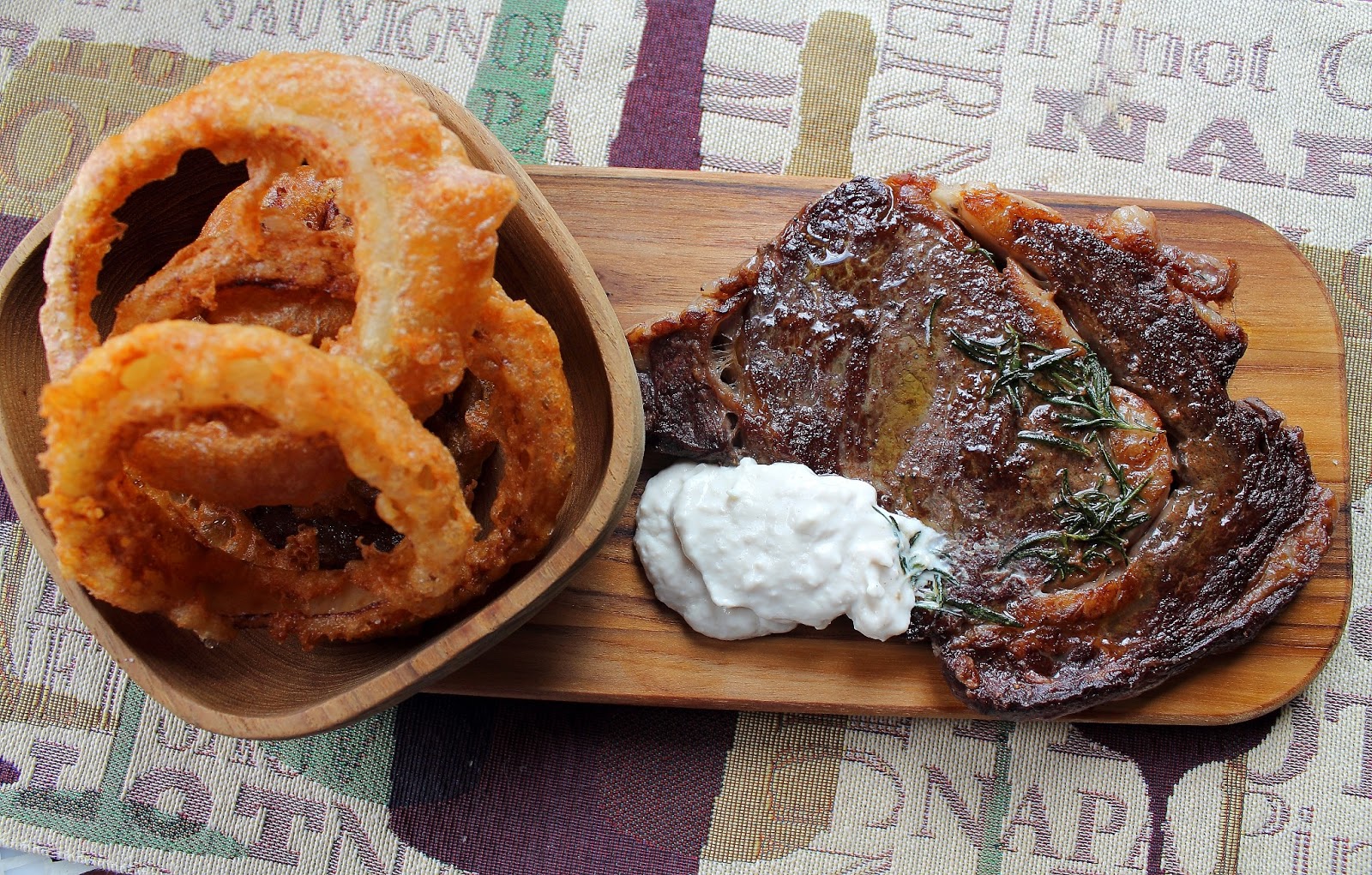 Ribeye steak with Crispy Sweet Onion Rings and Horseradish Cream by