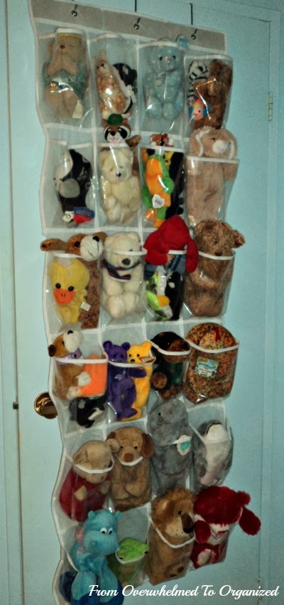 Overdoor shoe bag installed to hold stuffed animals.