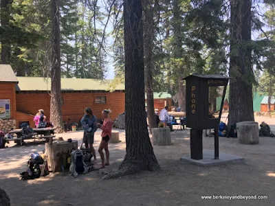 people relaxing at Reds Meadow shuttle stop at Devils Postpile National Monument in Mammoth Lakes, California