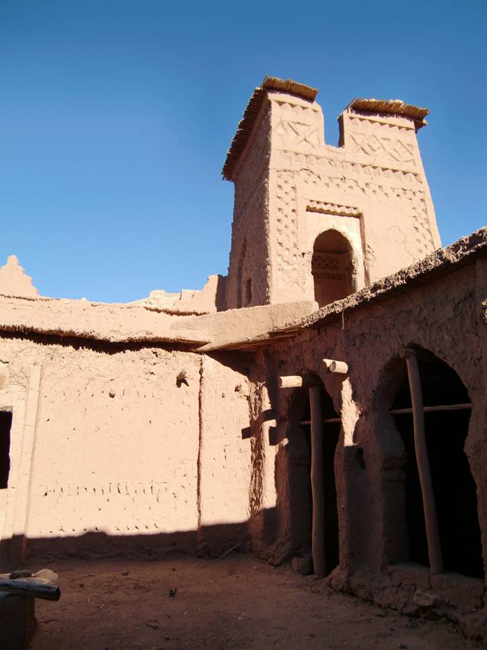 The Ksar of Aït-Ben-Haddou is a striking example of southern Moroccan architecture. The ksar is a mainly collective grouping of dwellings. Inside the defensive walls which are reinforced by angle towers and pierced with a baffle gate, houses crowd together - some modest, others resembling small urban castles with their high angle towers and upper sections decorated with motifs in clay brick - but there are also buildings and community areas.