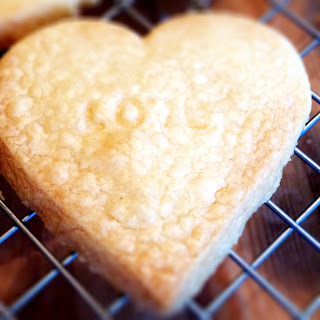 Shortbread biscuit cooling on tray with love stamp