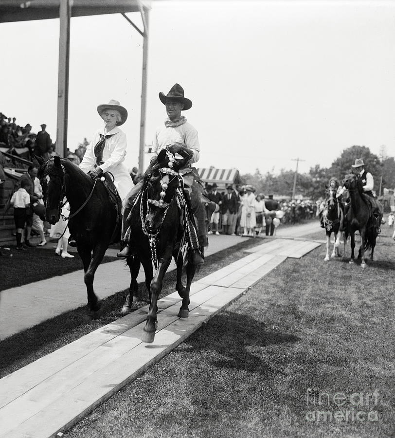 Annie Oakley riding with Fred Stone