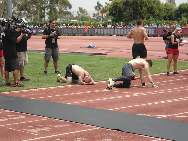 Athlete's laying on the ground, exhausted, at the end of a 400m sprint competition at the 2012 CrossFit Games