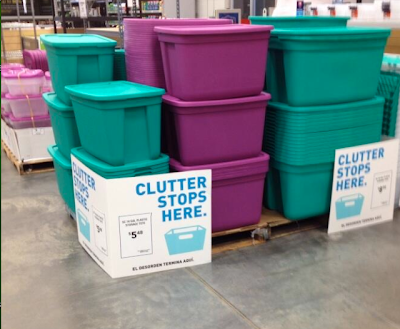 plastic bins being sold, with a sign that says: Clutter stops here.