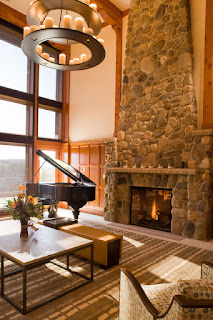 Stony Rustic Fireplace Mantels to Decorate Your Rustic Living Room Fantastic View of the Living Room with Stone Rustic Fireplace Mantels and Unique Chandelier above it