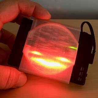 Photo of an electronic device, part of which is glowing red