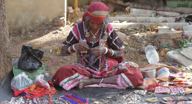 Tribal woman and her trinket shop on the streets of Hampi, Karnataka, India