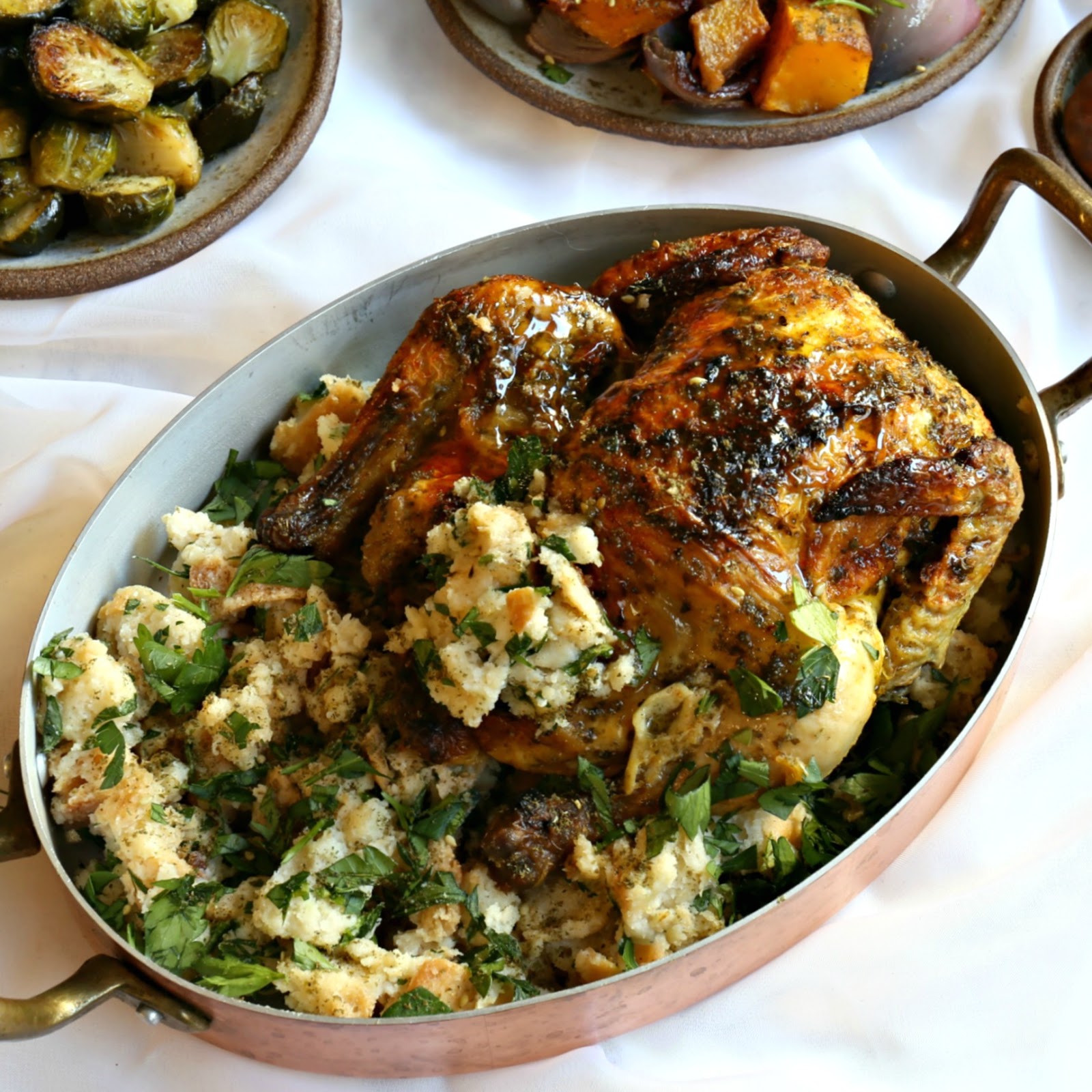 Roasted and stuffed Cornish game hen along with Middle Eastern spiced side dishes.