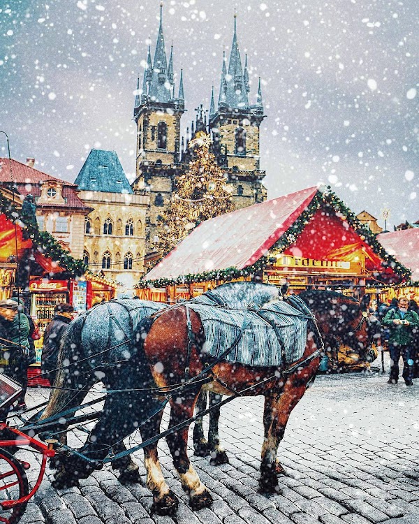 Snow in christmas prague at old town square