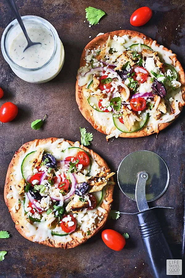 Individual Greek Pita Pizzas ready to slice with the pizza cutter and eat