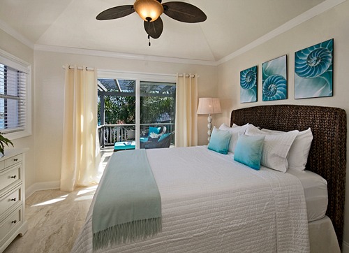 Tropical Ocean Blue Bedroom with Dark Rattan Bed