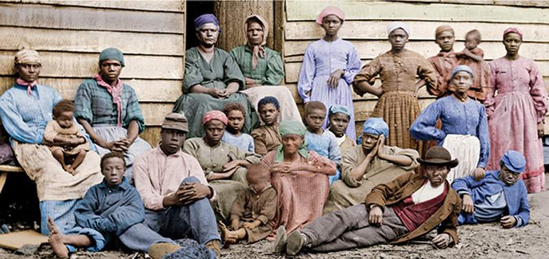 Slaves have their picture taken on a southern plantation.